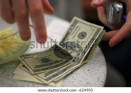 A male paying the bill at a restaurant.