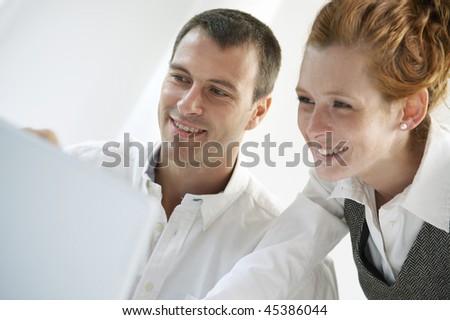 Young man and women working with laptop