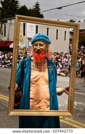 SEATTLE, WA - JUNE 16, 2012: Purple Mark frames himself during the annual Fremont Summer Solstice Parade in Seattle on June 16, 2016. The parade celebrates the start of summer.