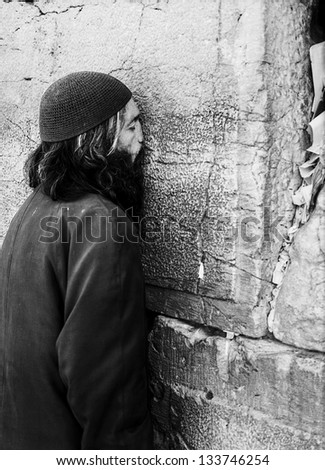 JERUSALEM, ISRAEL - JANUARY 27, 2013: An unidentified Jewish man prays at the Western Wall in the Old City of Jerusalem on January 27, 2013.
