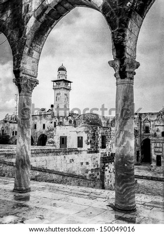 An Islamic minaret is framed by the arches of one of the gatehouses on the Temple Mount in the Old City of Jerusalem in Israel. (Scanned from black and white film.)
