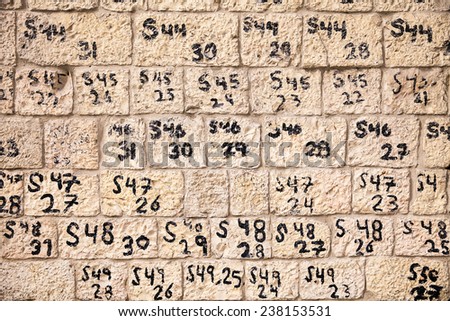 JERUSALEM, ISRAEL - JANUARY 26, 2013: Numbers and letters identify the order of stone blocks recently reconstructed as part of renovations of a historic wall near the Old City of Jerusalem in Israel.