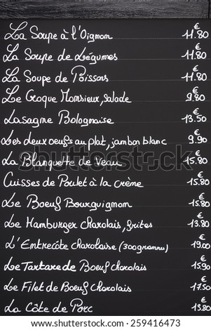 A typical cafe menu written on chalk on a blackboard as seen in the town of Beaune in France.