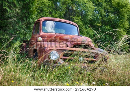 WALDRON, USA - JUNE 18, 2015: A frontal view of an old International Harvester truck that is slowly rusting on a farm on Waldron Island shows the front grill, hood, and insignia on the grille.