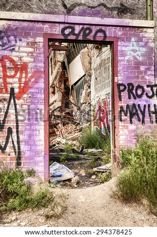 DETROIT, USA - JUNE 12, 2015: A graffiti painted doorway at the old Fisher Body Works Factory shows some of the decayed remains of the old automotive factory.