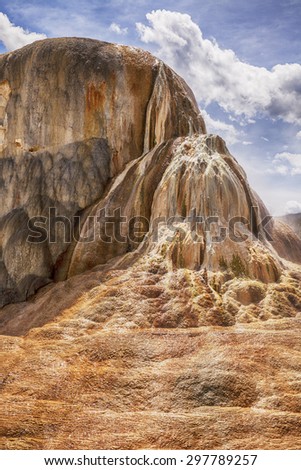 Orange Spring Mound in the Mammoth Hot Springs area in Yellowstone National Park differs from other terrace formations as its large mounded shape result from slow water flow and mineral deposition.
