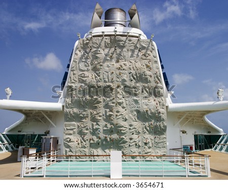 A recreational climbing wall located on the aft side of the main smokestack on board a cruise ship.