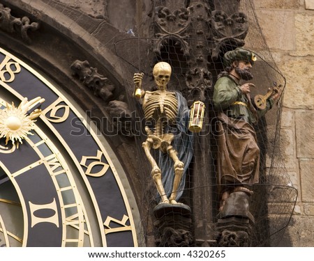 Prague\'s astronomical clock is a landmark. The clock face is surrounded by medieval sculptures including the skeleton that represents Death.