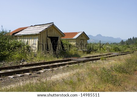 A couple of old railroad buildings, maybe an old station, located in a small town on the Oregon Coast. The old maintenance sheds are apparently not used and are in poor condition.