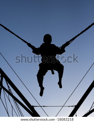 stock-photo-a-black-silhouette-of-a-boy-jumping-and-being-suspended-in-mid-air-by-bungee-cords-18083218.jpg