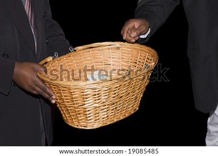 A basket being passed around at a Methodist Church in a South African township to collect donations.