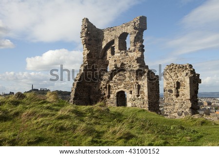 The ruins of St. Anthony\'s Chapel remain as a single wall in Holyrood Park in Edinburgh, Scotland. In the distance, the Scottish National Monument on Calton Hill is visible at the left.