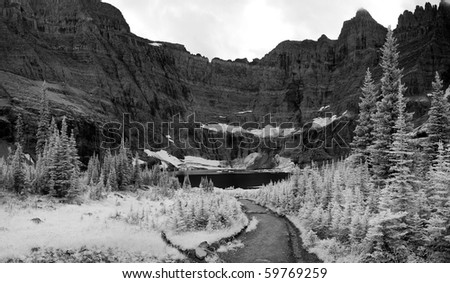 Trail leading to Iceberg Lake in Glacier National Park. This image shows the forest and the headwall mountains at above the lake. Taken in black and white infrared.