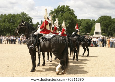 LONDON, ENGLAND - JULY 8: A squad of of the British Royal Cavalry with their horses perform during the traditional daily changing of the guard on July 8, 2006 in London, England.