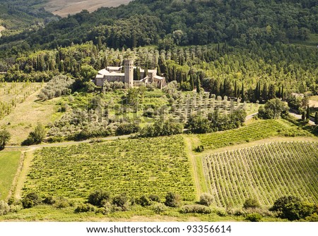 A scenic viewpoint of an old monastery estate surrounded by olive orchards and vineyards in the hilly countryside of Umbria near Orvieto in Italy.