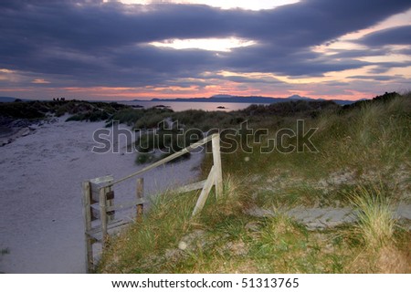 Sunset and boardwalk at Arisaig looking over toward the island of Skye, Scotland