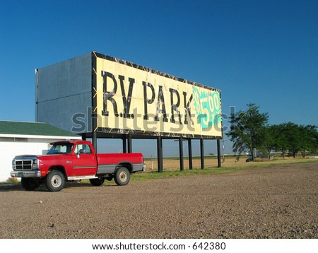 billboard for an rv park set against a blue sky