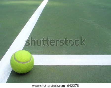lone tennis ball that has rolled to a stop in the 
