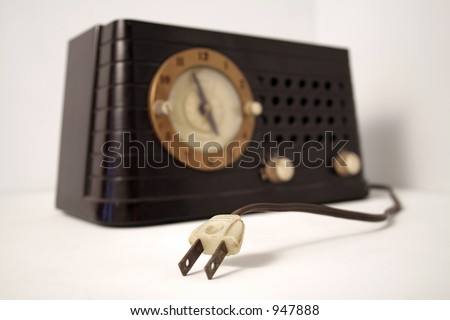 unplugged, vintage clock radio set against a white background - shallow depth of field