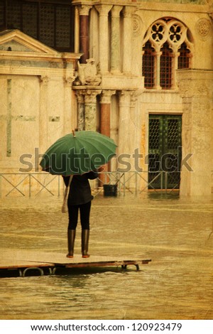 Stylized photo of unknown person with umbrella in Venice