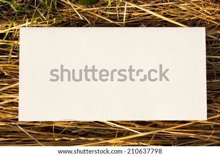 white blank paper on straw grass background