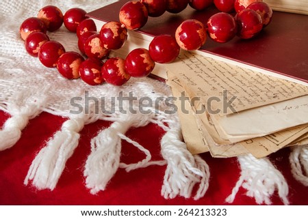 old letters, book and wooden beams on fabric background