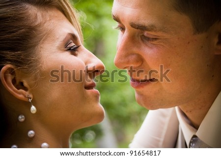 young couple face to face on their wedding day