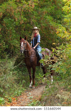 Cowgirl relaxing with horse in the forest