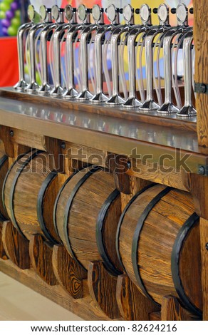 A taps for spilling beer or soda in a glittering bar