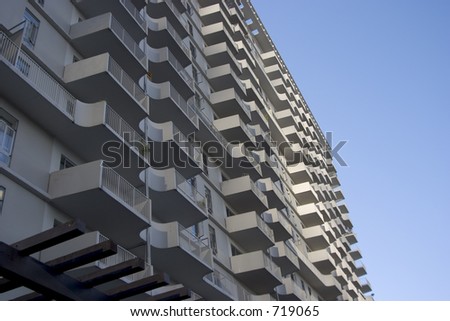 A large city apartment building displays it\'s face of modern balcony\'s.