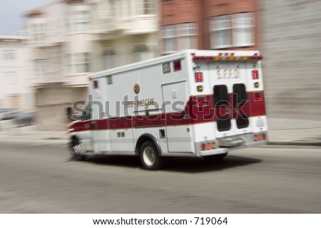 An ambulance blazes by, it\'s sirens whaling.  An intensional camera blur gives a feeling of a rushed tension to the scene.