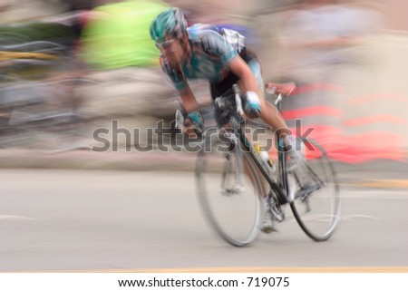 An intentional slow-shutter blur, gives this bike racer feeling of motion and intensity.  It also  removes all the sponsors from his jersy (And we like that).