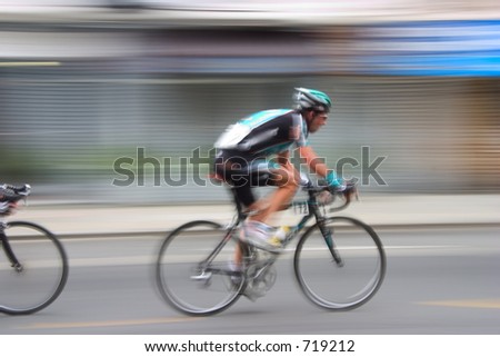 An intentional slow-shutter blur, gives this bike racer feeling of motion and intensity.  It also  removes all the sponsors from his jersey (And we like that).