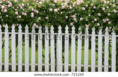 A picket fence topped by flowers.