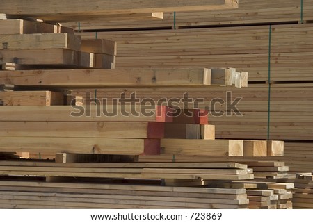 A pile of lumber at a lumberyard.