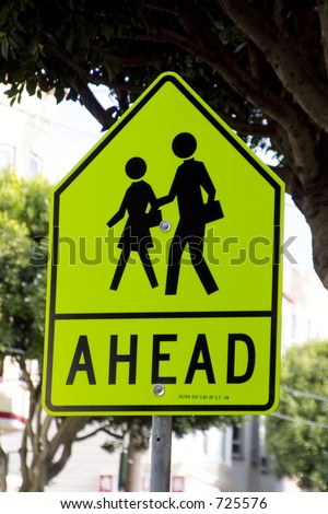 A pedestrian sign warning of school kids in the area.