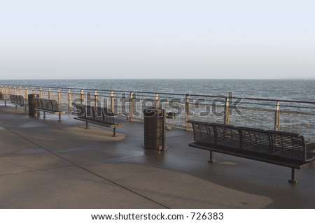Metal benches overlook the water of San Francisco Bay.