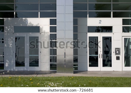 Two doors leading to the inside of a no-name generic corporation.