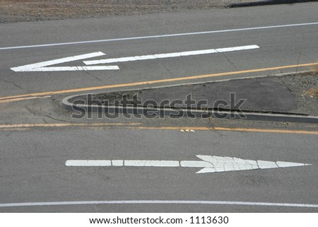 Painted road arrows pointing in the opposite direction.