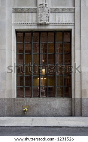 A grid window on a neoclassical building in New York City.