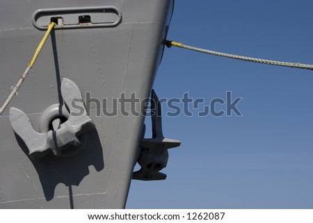 Giant Anchors hang from the bow of a ship.