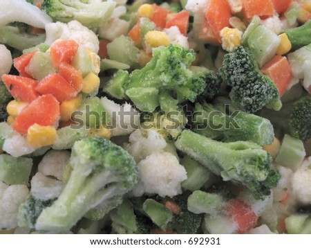 frozen vegetables in macro close up. You can see the icing on the broccoli and carrots.