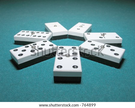 Double Dominoes ordered like a flower on a lighted table.