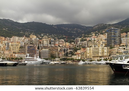 Monaco harbor with several high priced yachts on view. All ID info has been removed from signs and boats.