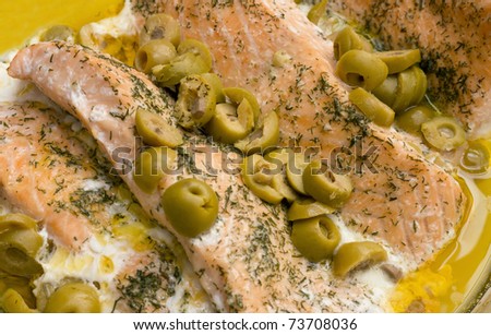 Salmon with dill weed and anchovy olives in a bed of butter.