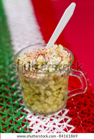 Mexican Corn Dish Known As Esquites. Mexican dish known as esquites which is corn cooked in chicken broth with epazote herb and seasoned with mayonnaise, shredded white cheese and piquin red chili.