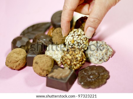 Grabbing a Truffle Chocolate Coated With Nuts