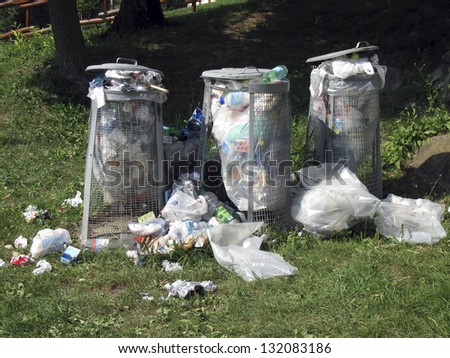 three trash cans in the woods