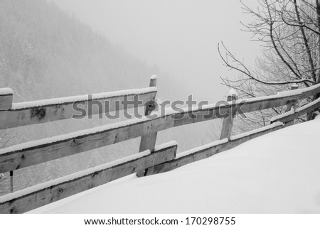 wooden fence in winter, black and white photo