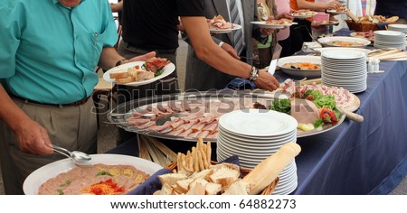 catering service, people self serving on a buffet